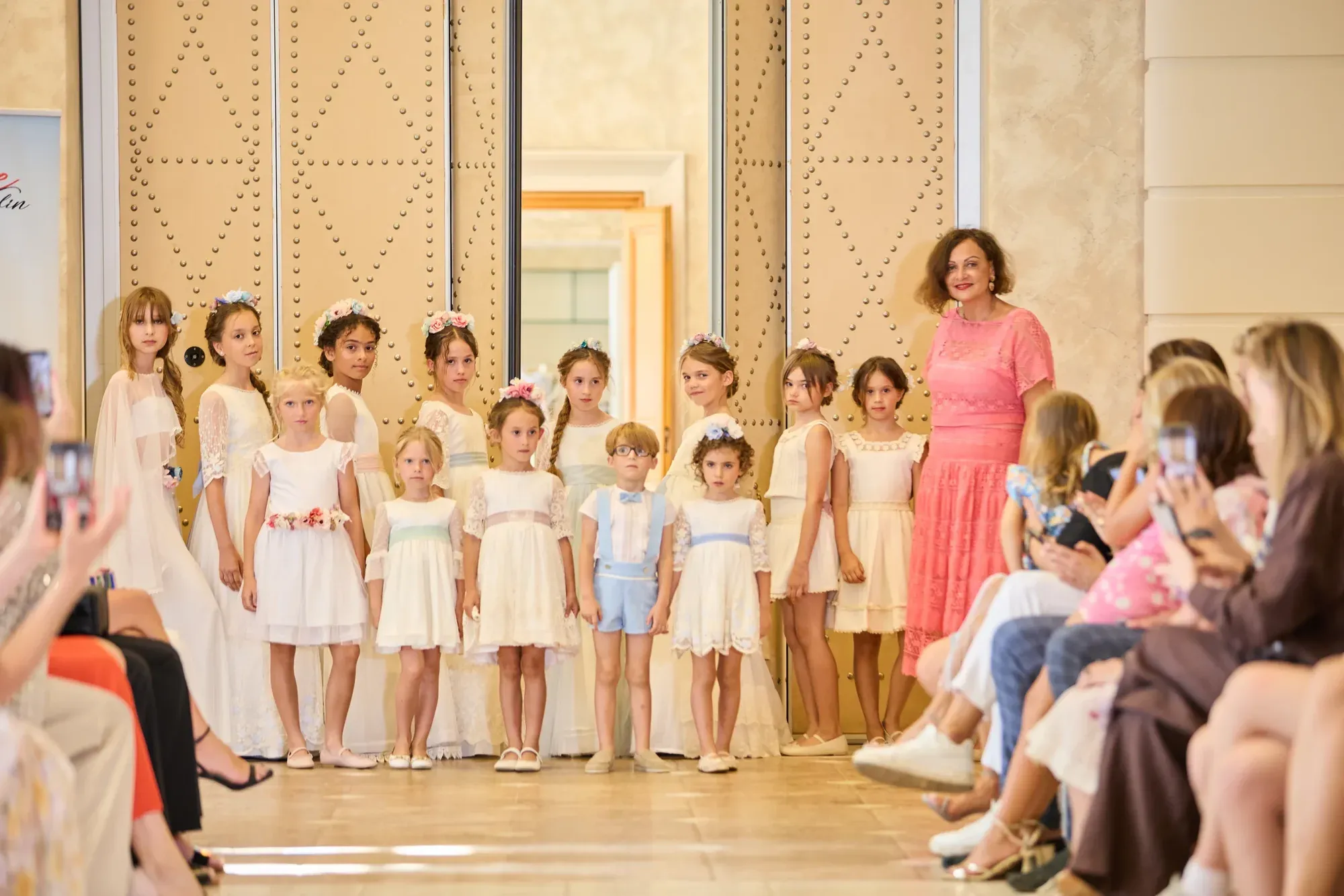 Students of Be Your Best Academy of Marbella on stage with founder Iryna Malpa at the Villa Padierna fashion show.