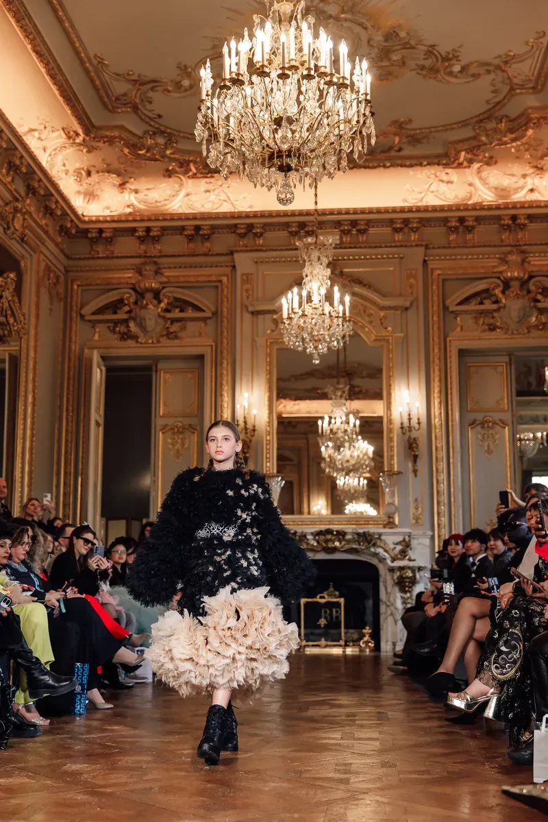 A model on the runway at a professional fashion show.