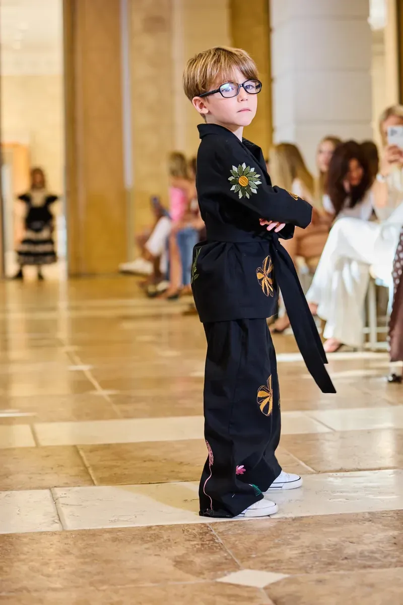 A young model on the runway at a fashion show.