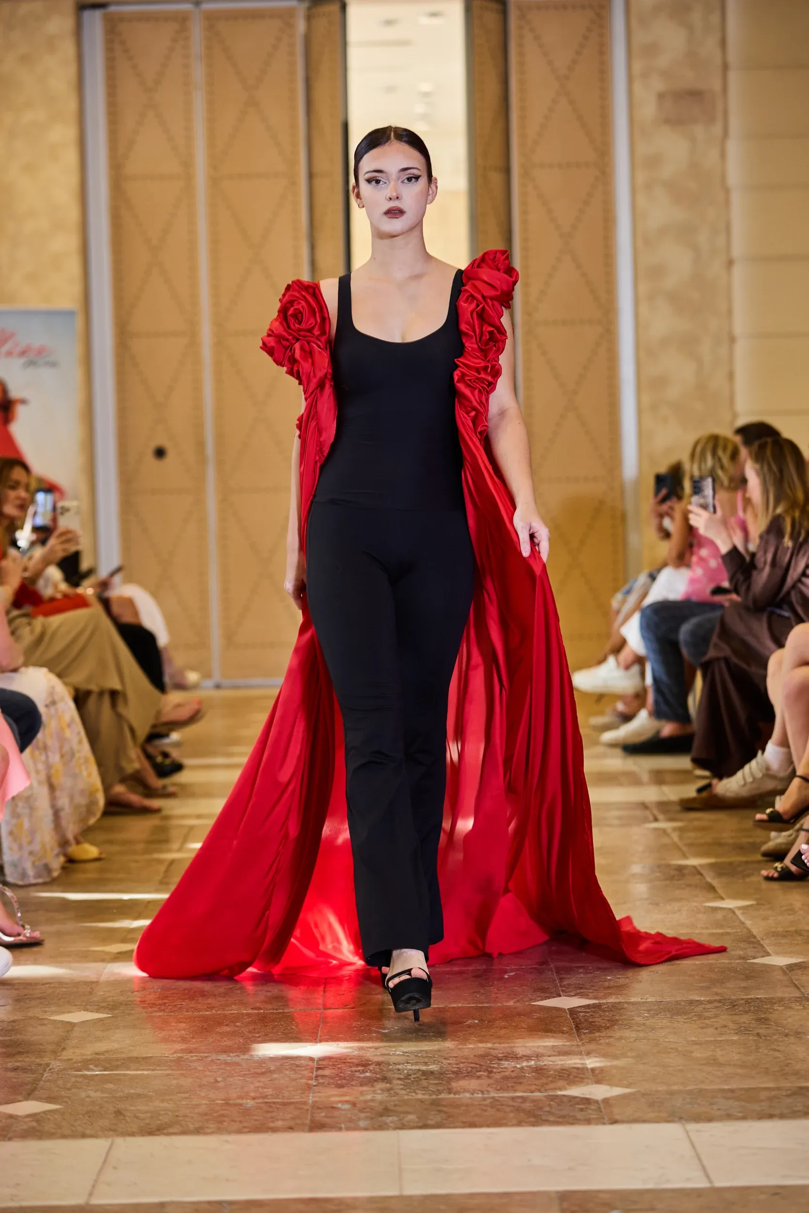 A model presents a couture look on the runway at a fashion event in Marbella.