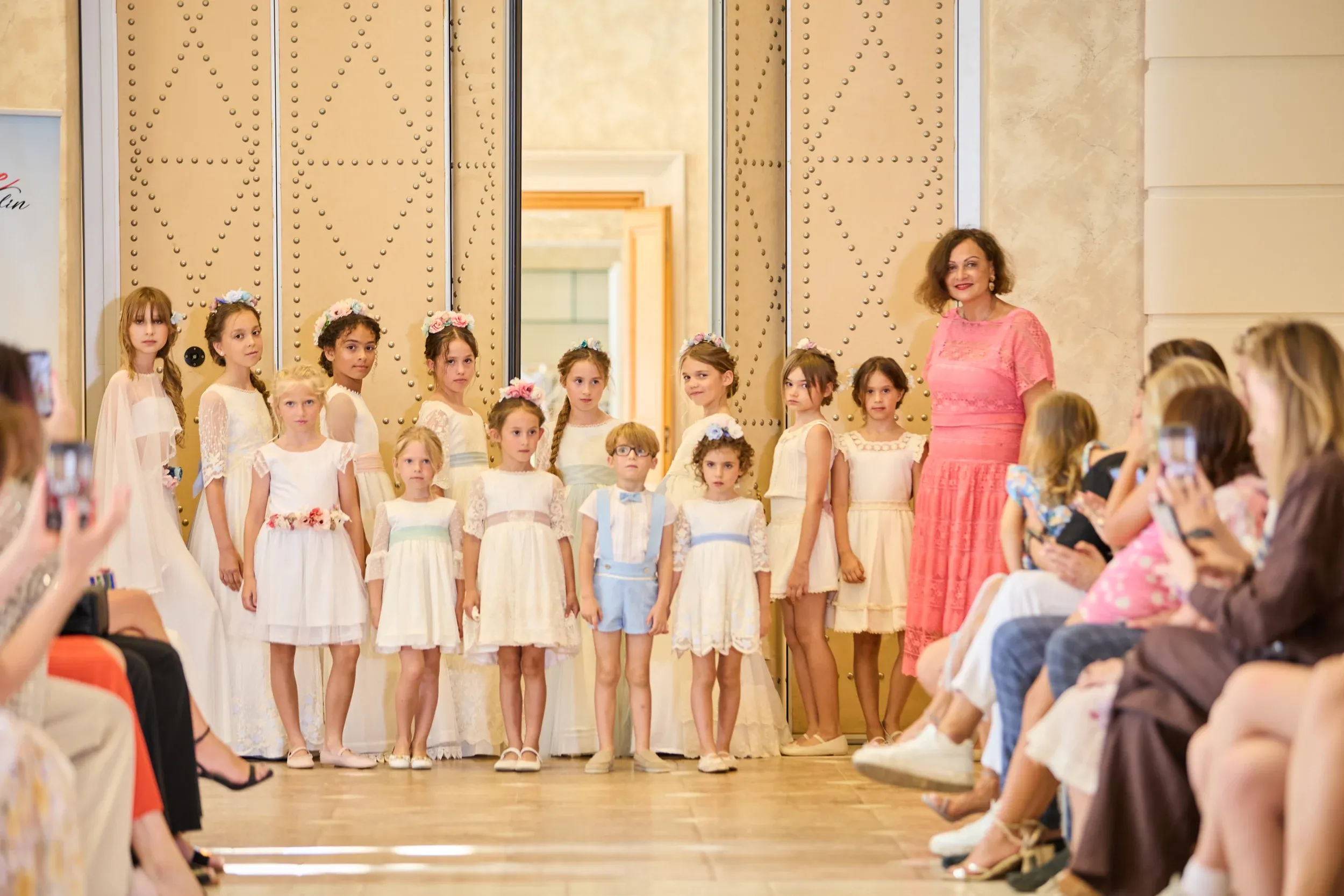 Children models of Be Your Best Academy on stage with the designer at the Villa Padierna fashion show in Marbella.
