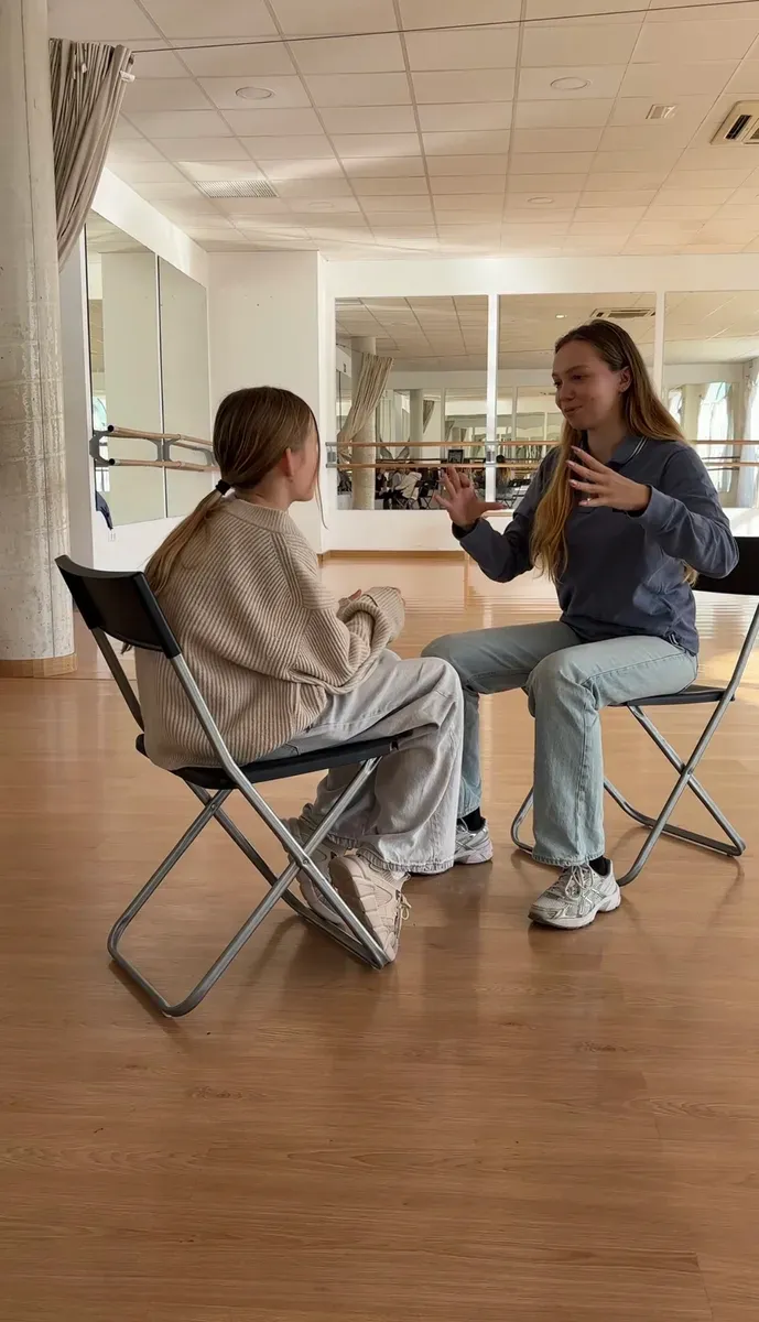 Two students practising communication and conversation in a class in Marbella.