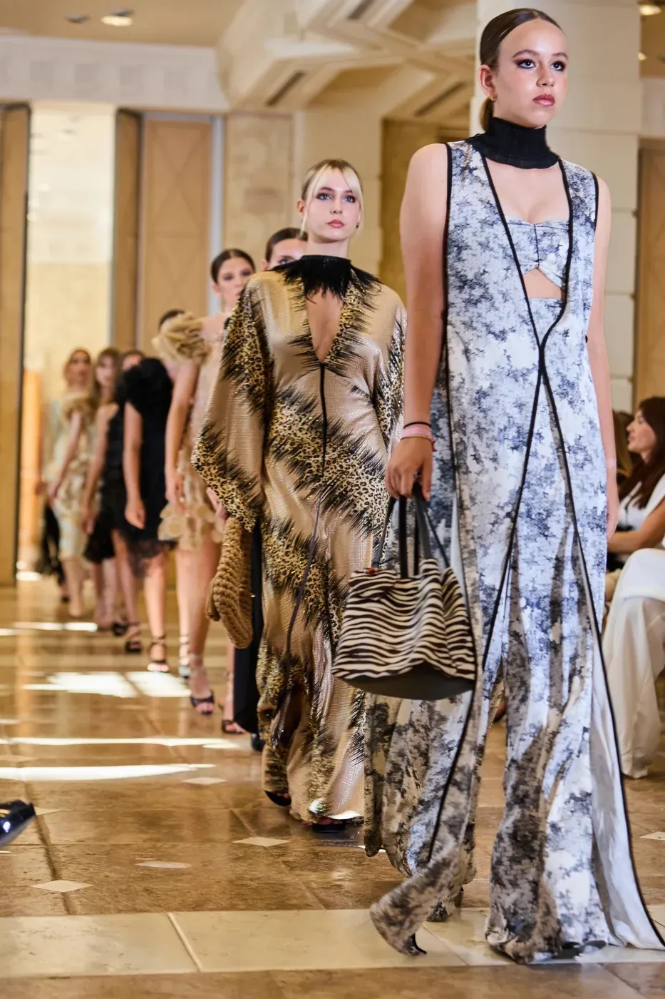 Students walking the runway together at a fashion show in Marbella.