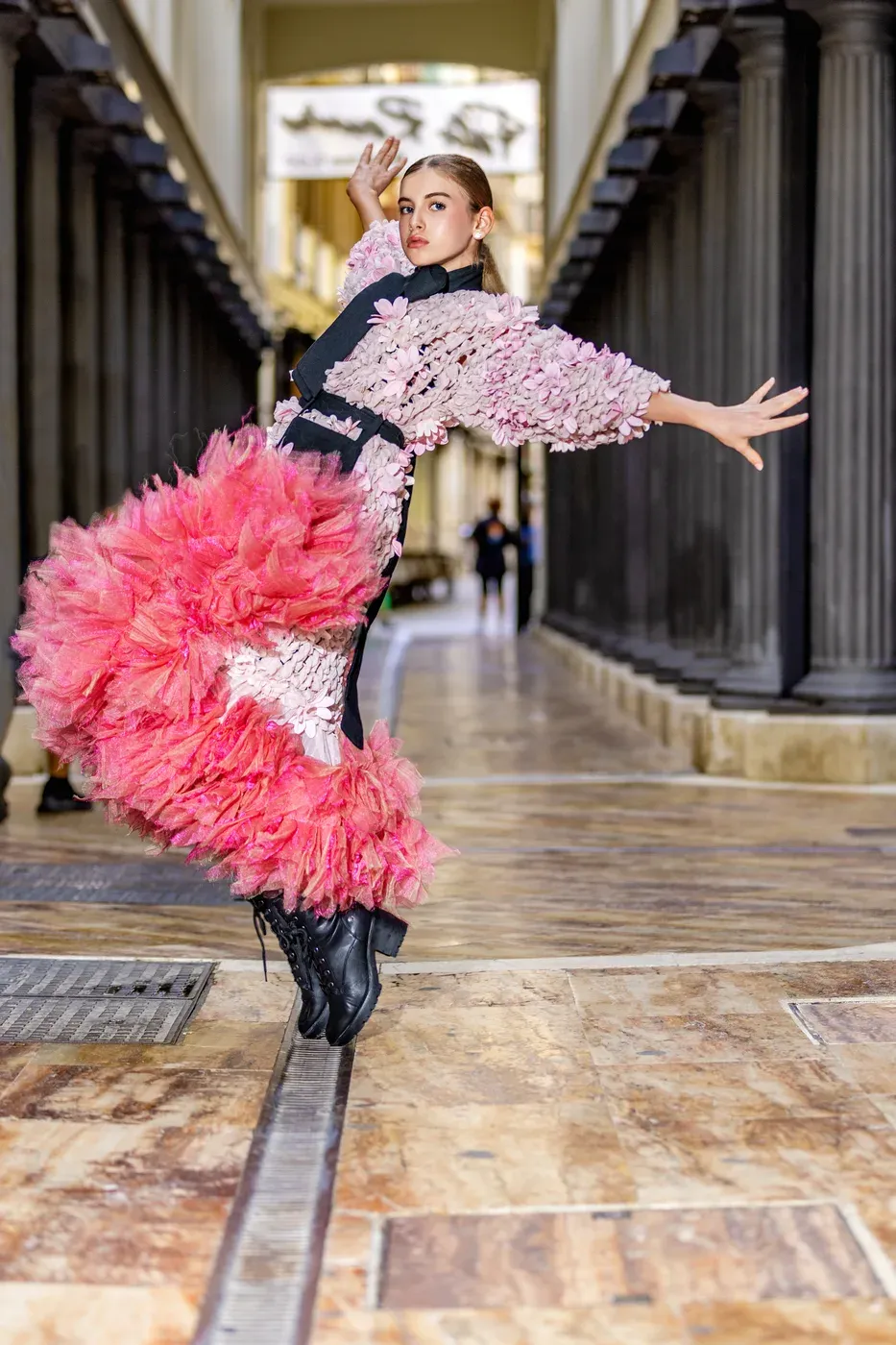A student modelling a pink floral couture dress in an editorial photoshoot in Marbella.