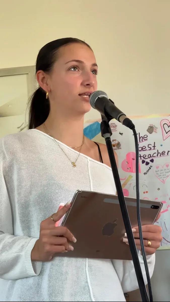 A student practising public speaking with a microphone at Be Your Best Academy, Marbella.