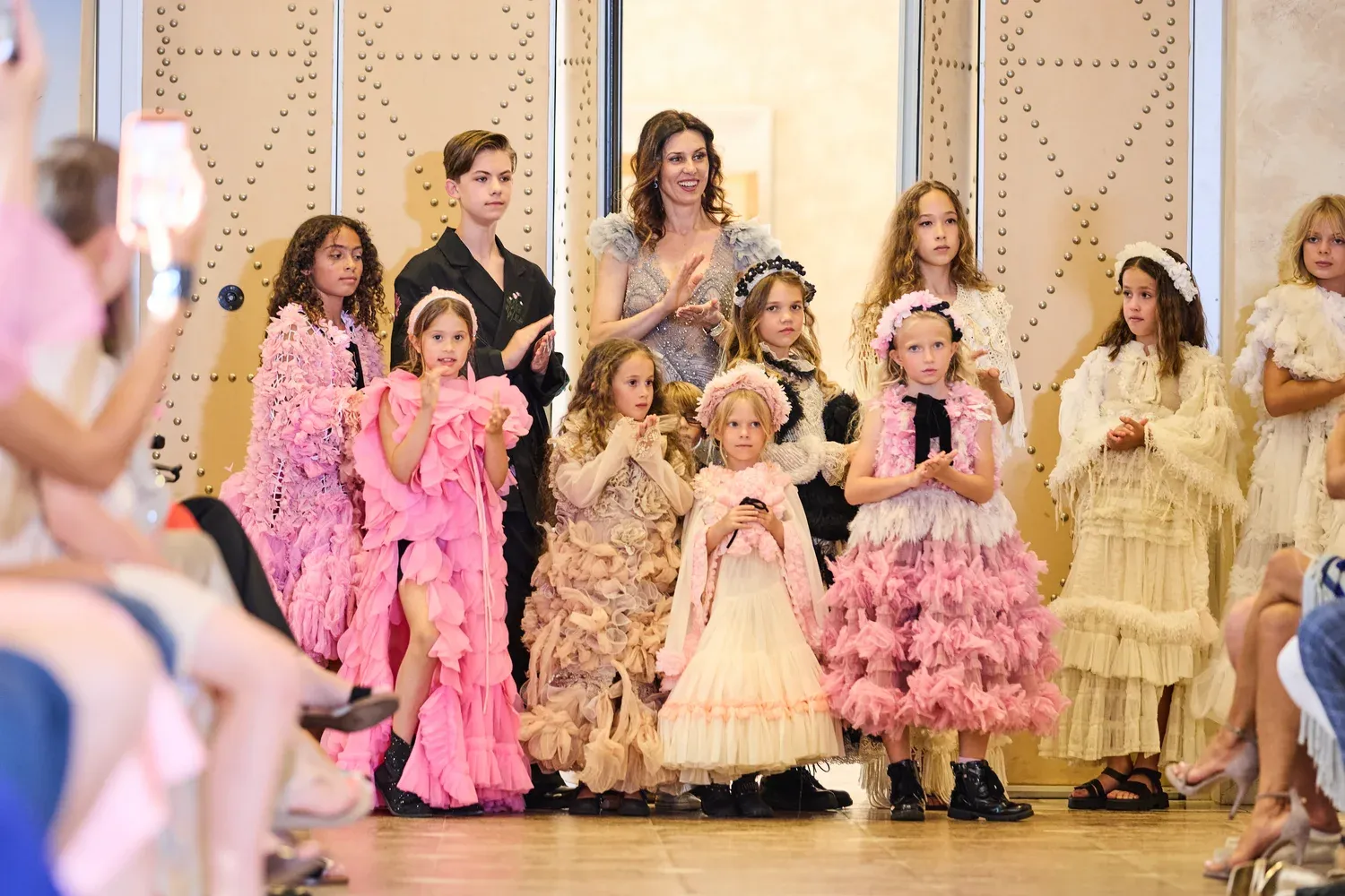 Students of Be Your Best Academy on stage together with founder Iryna Malpa at a fashion show in Marbella.