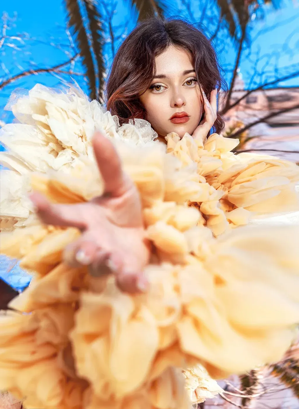 Editorial fashion photoshoot of a young model in a cream couture gown.